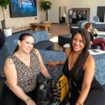 Couple of female professionals sitting at the lobby