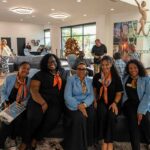 Professionals seating on one of the sofas in the lobby area during a big event