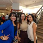 Three guests enjoying an event in the lobby